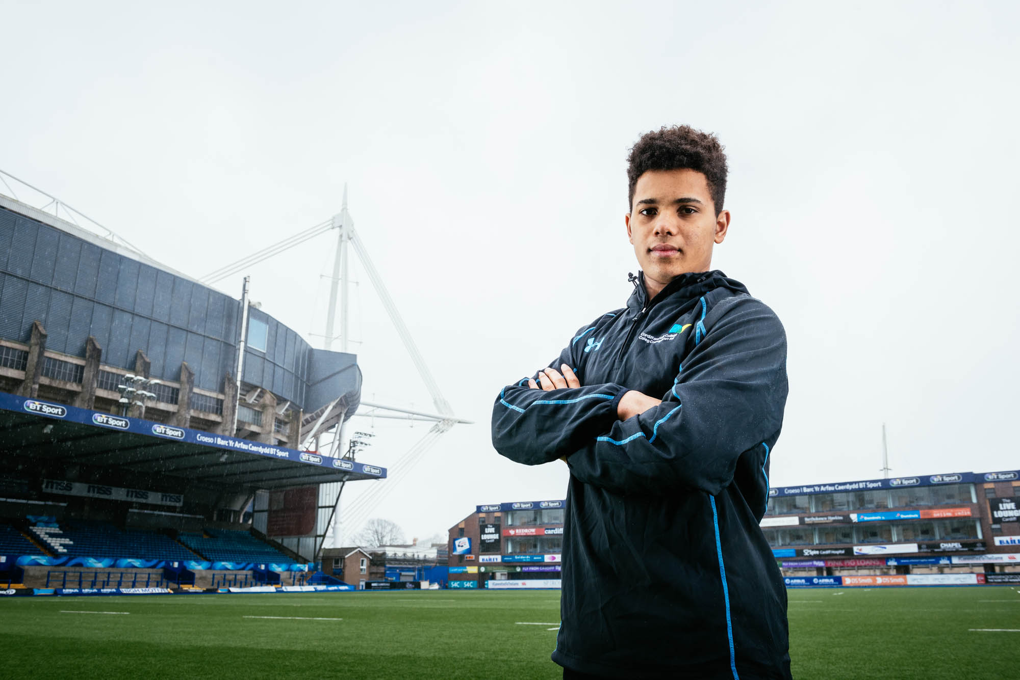 A photo of a rugby player at the arms park in cardiff with the millennium stadium behind
