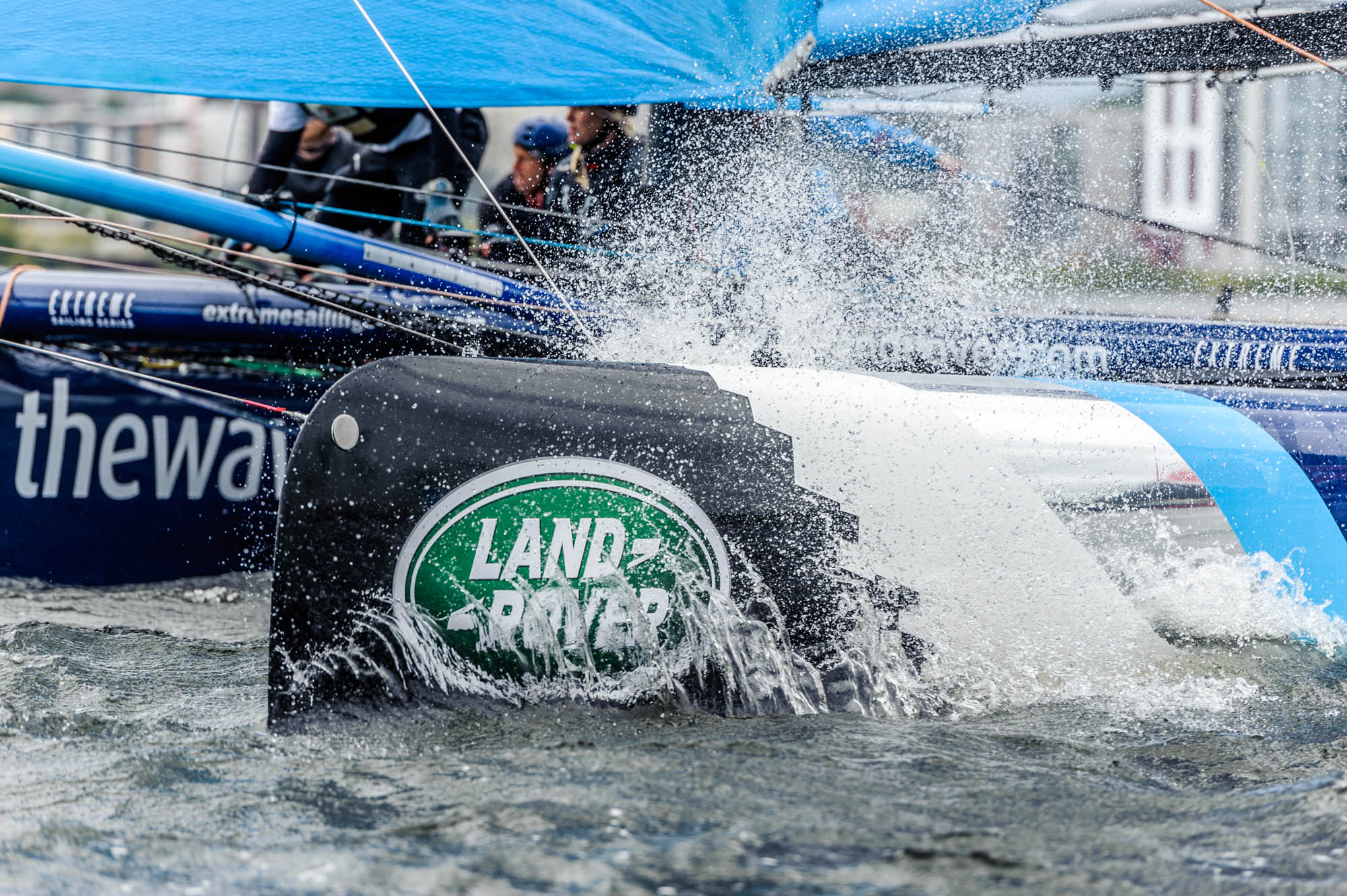 A photo of a super series catamaran kicking up spray in Cardiff